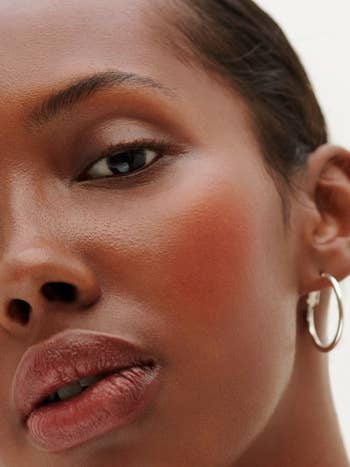 Another model with a darker skin tone with the blush on