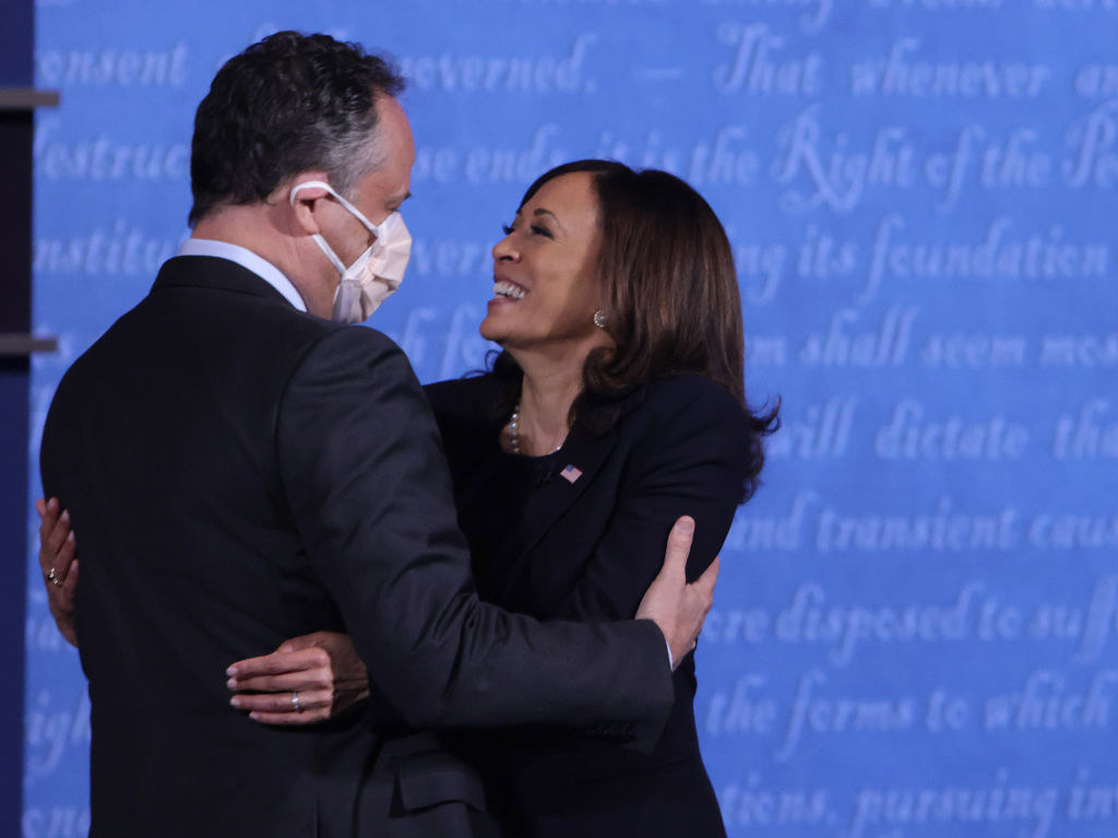 Doug Emhoff and Kamala Harris embracing on stage