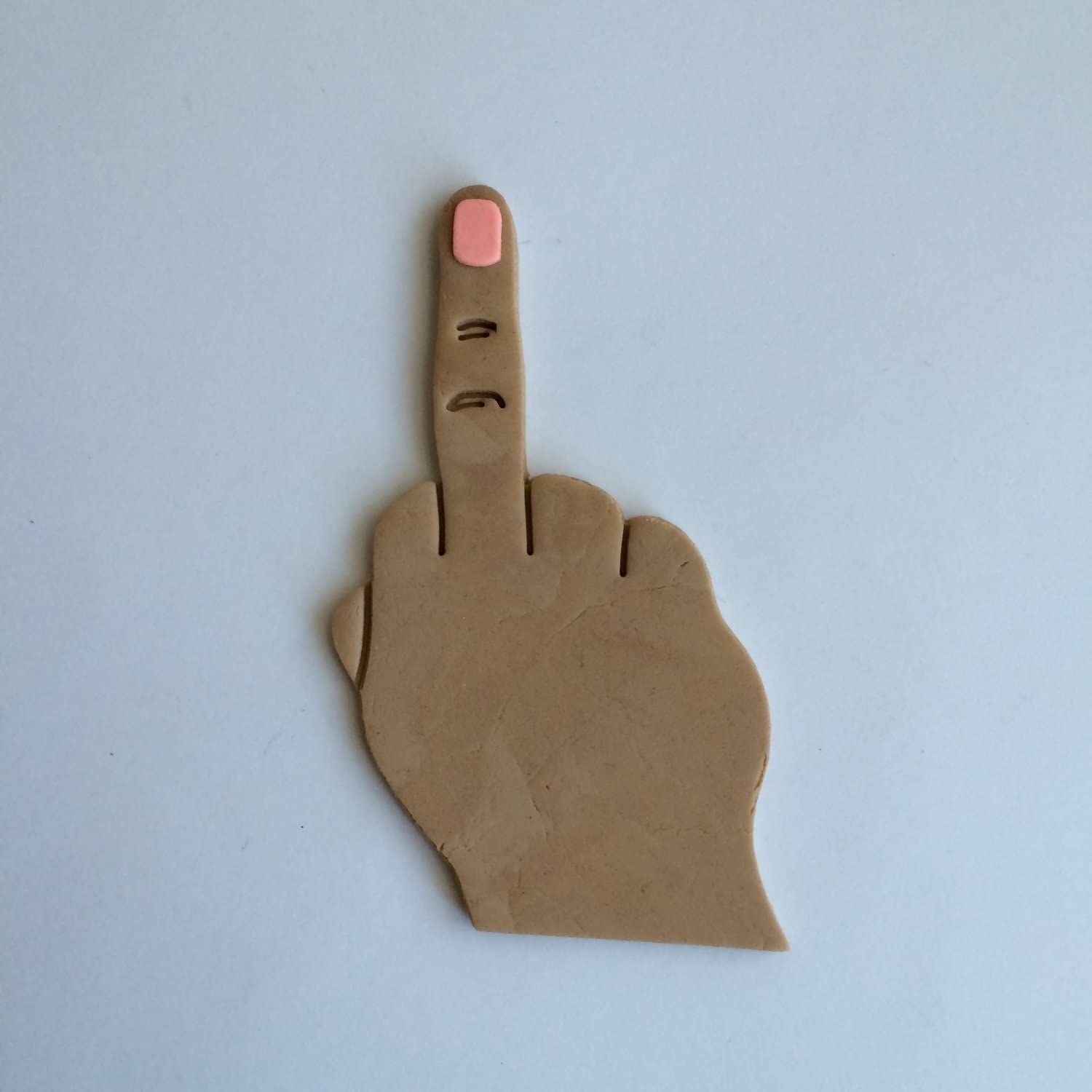 Cookie dough cut out to look like a hand giving the finger 