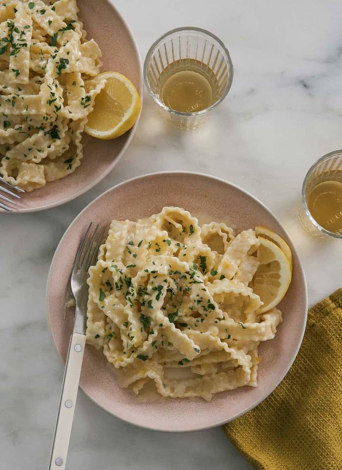 A bowl of lemony pasta with herbs.