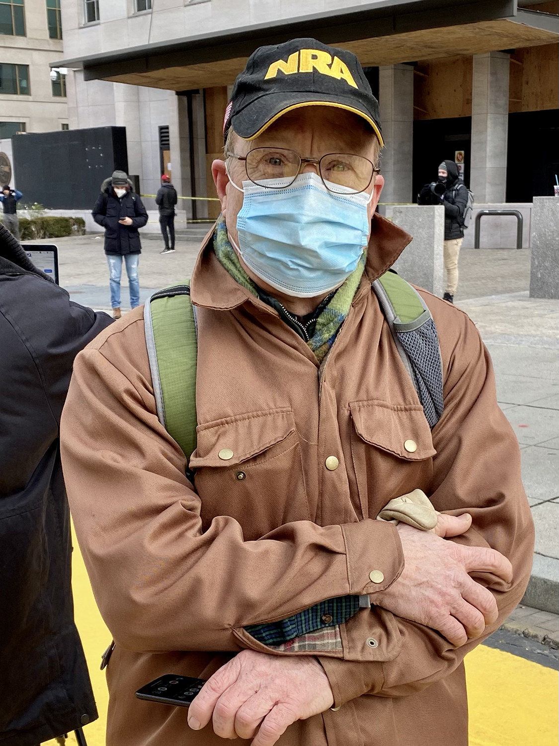 A man in an NRA hat and a mask