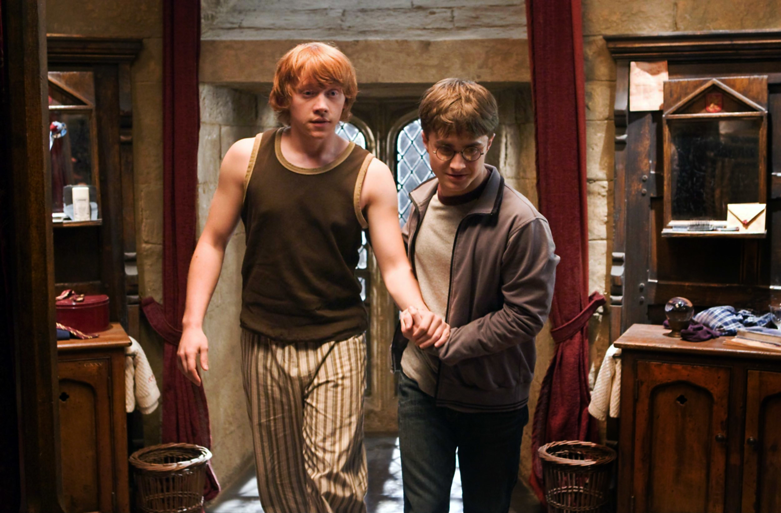 Harry helping Ron walk in the dormitories