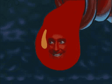 a human face grinning evilly in a drop of hot sauce