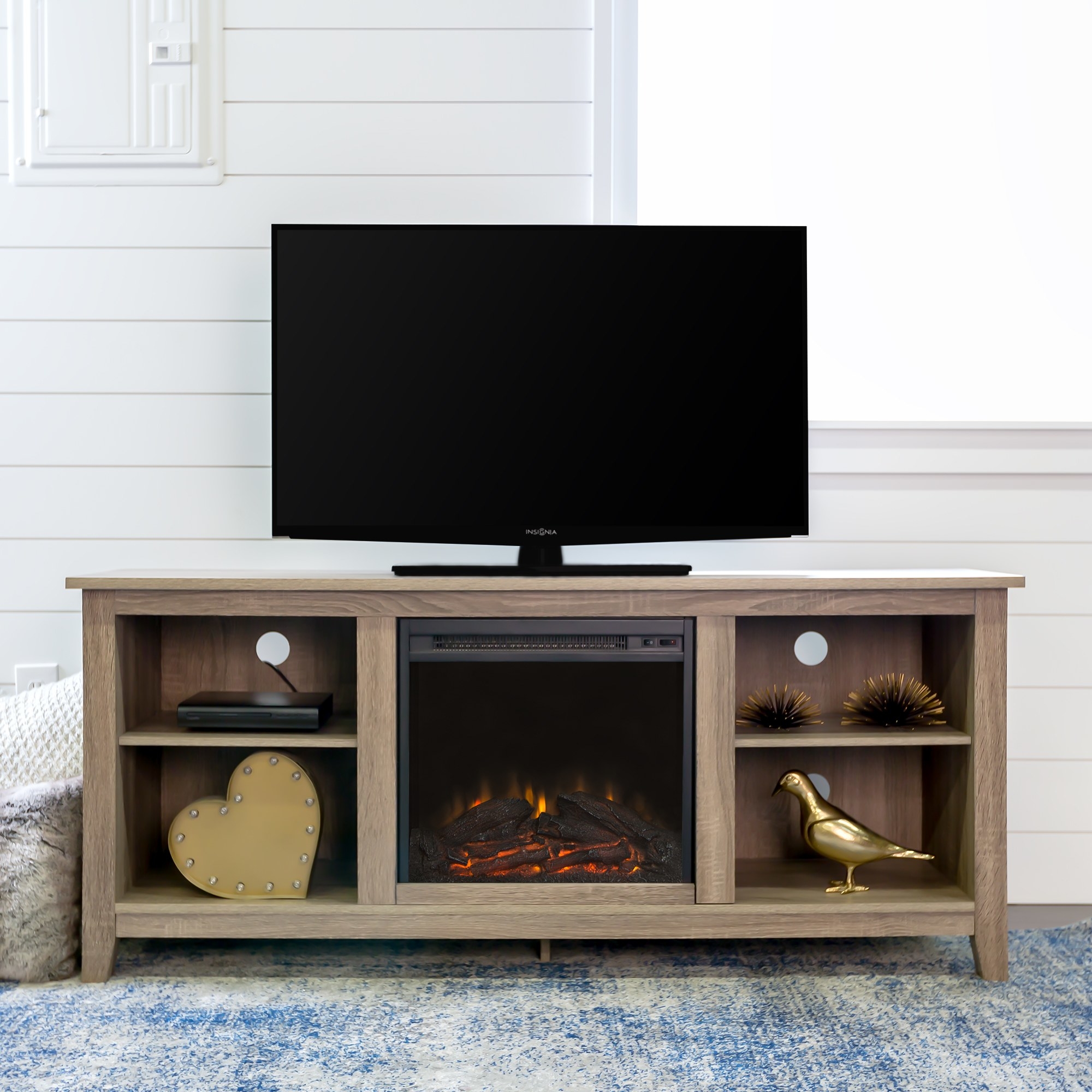 The TV stand with an electric fireplace in the middle and two shelves on either side