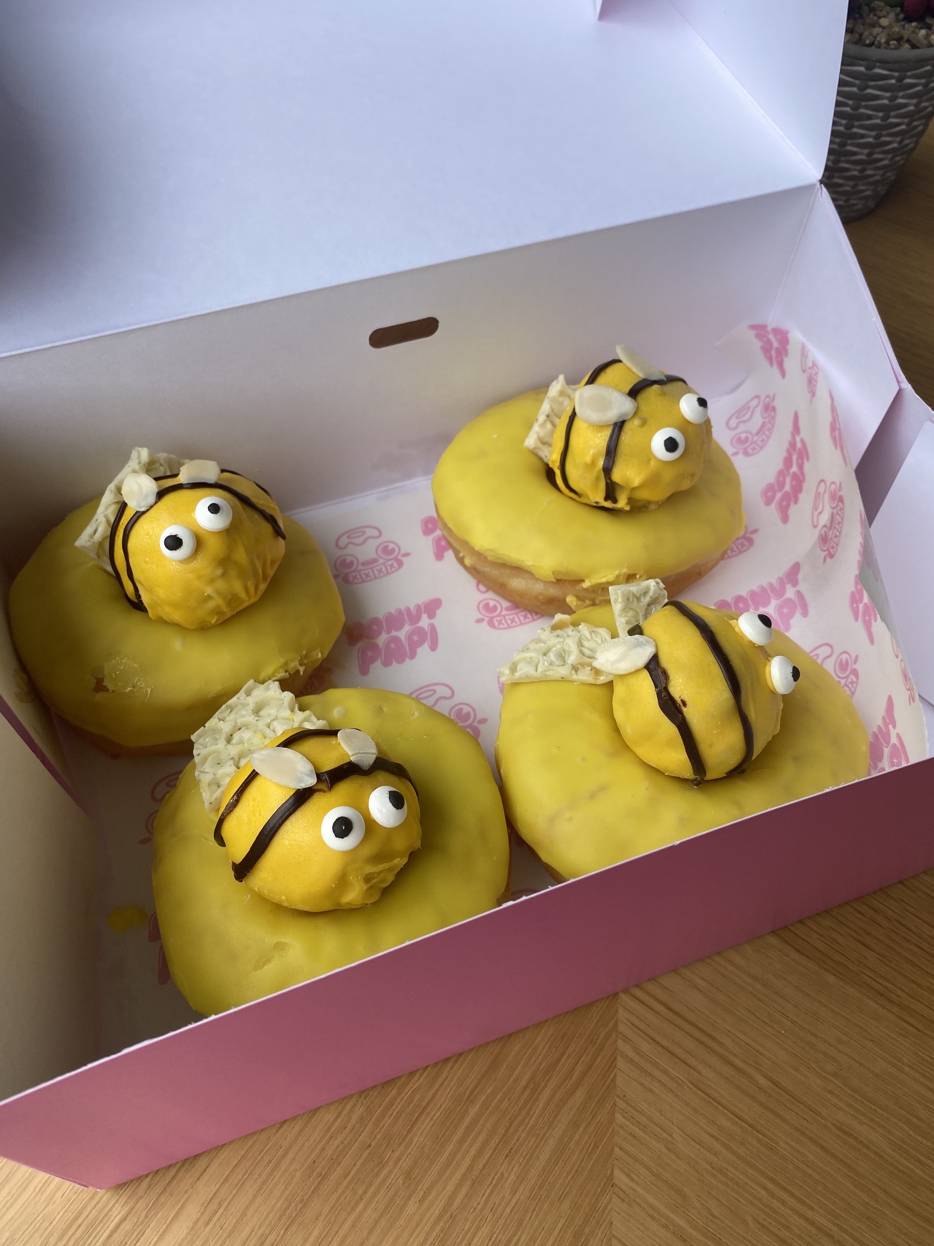 A box of four bee doughnuts