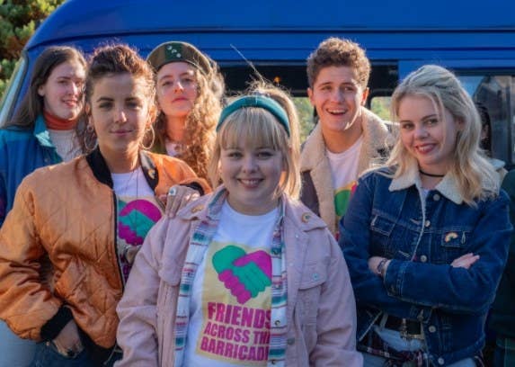 The cast of Derry Girls smile at the camera