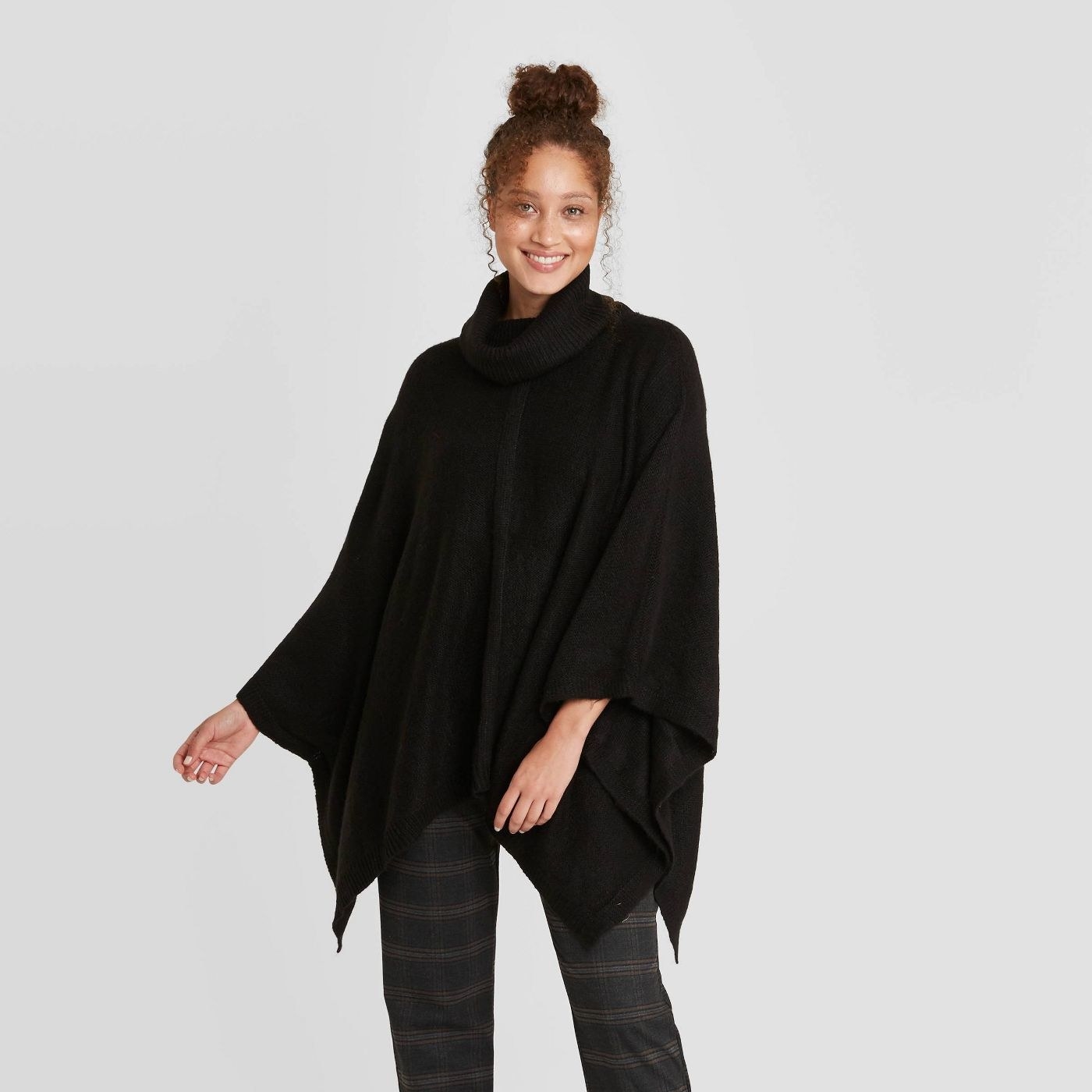 Model in black poncho