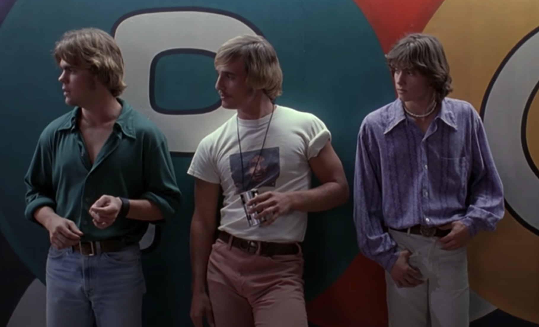 Matthew McConaughey leaning against a wall as Wooderson in Dazed and Confused