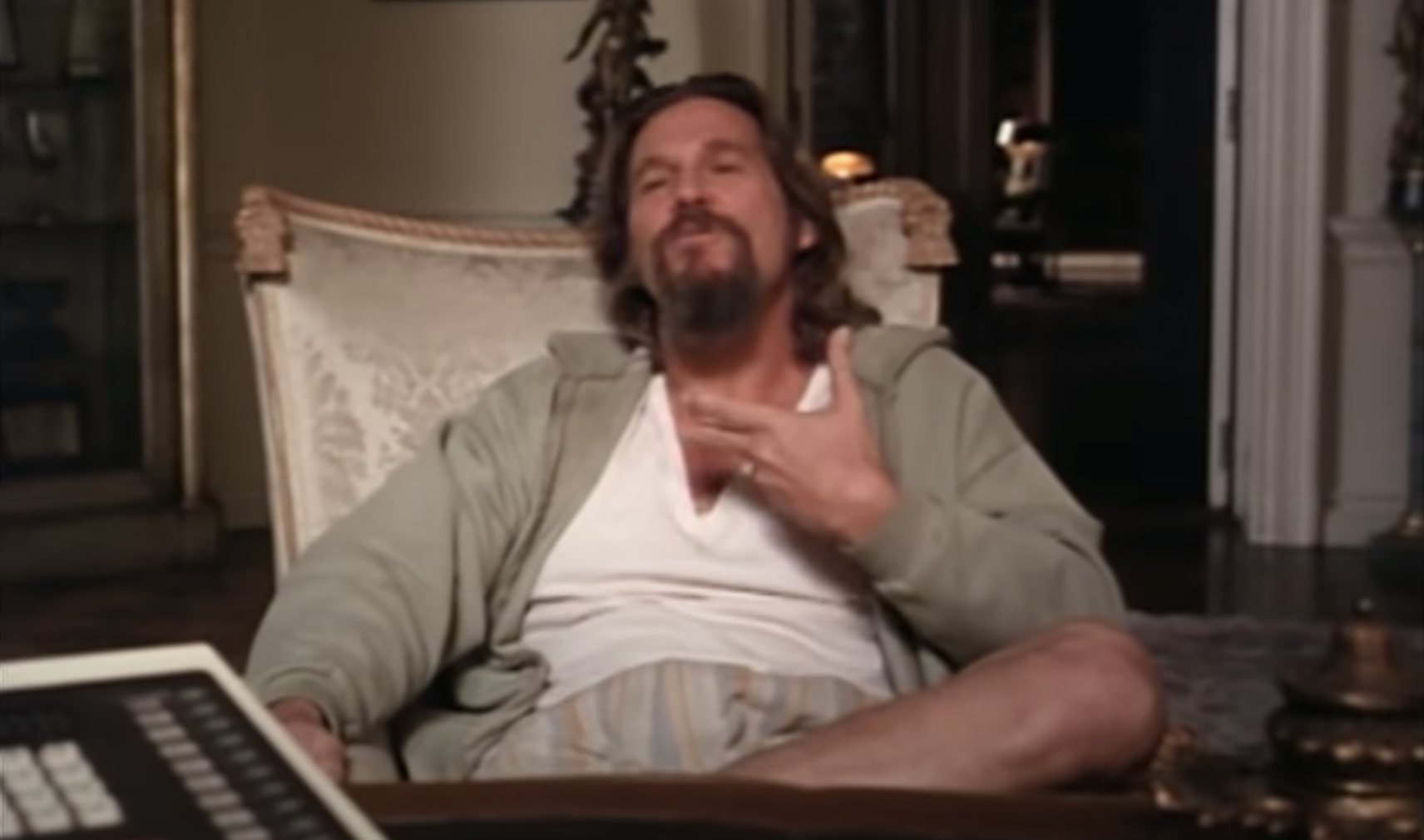 Jeff Bridges lounging in a chair as The Dude