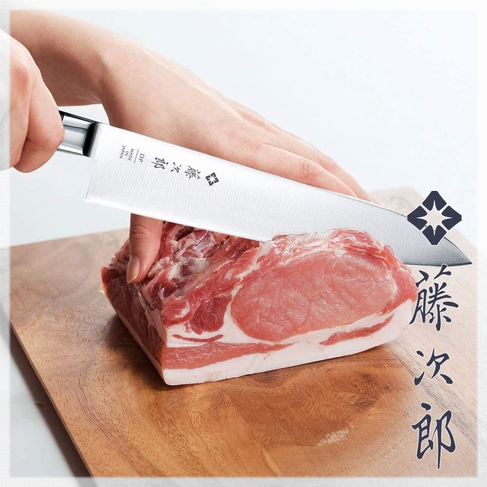 Picture of hand using a knife to cut meat