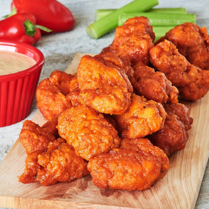 Boneless wings styled on a wooden board