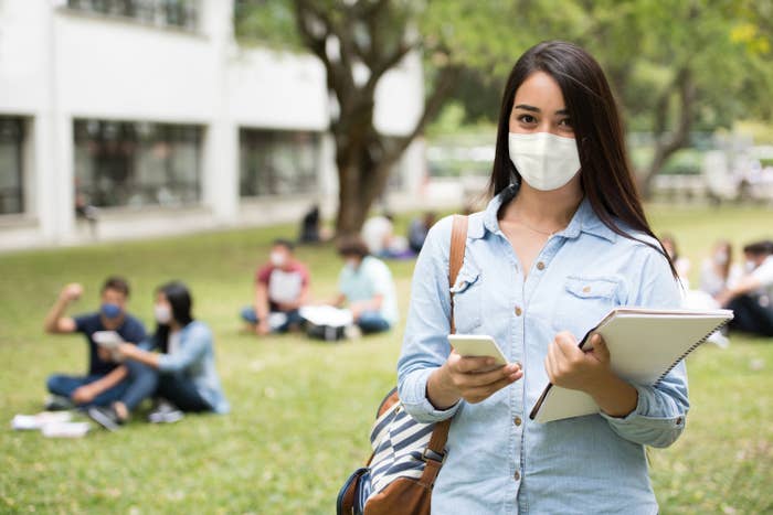 College student wearing a face mask on campus