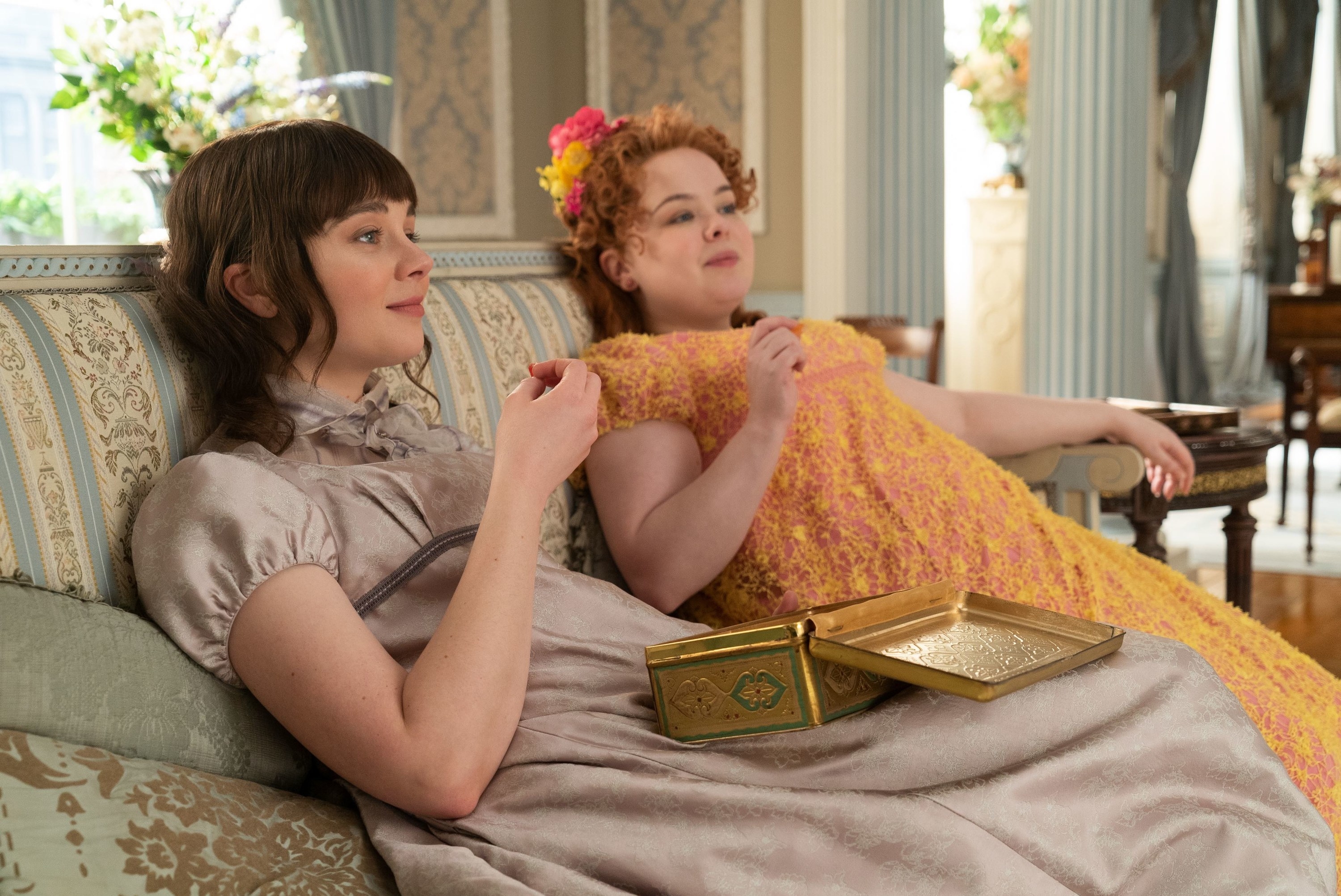 Eloise and Penelope eating chocolates in &quot;Bridgerton&quot;