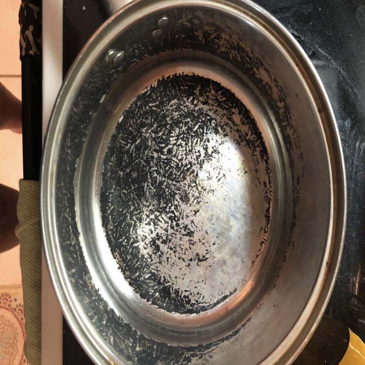 a reviewer photo of a pot with black burnt bits on the bottom