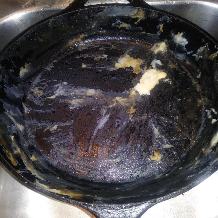 a reviewer showing a mess of food caked onto the bottom of their pan