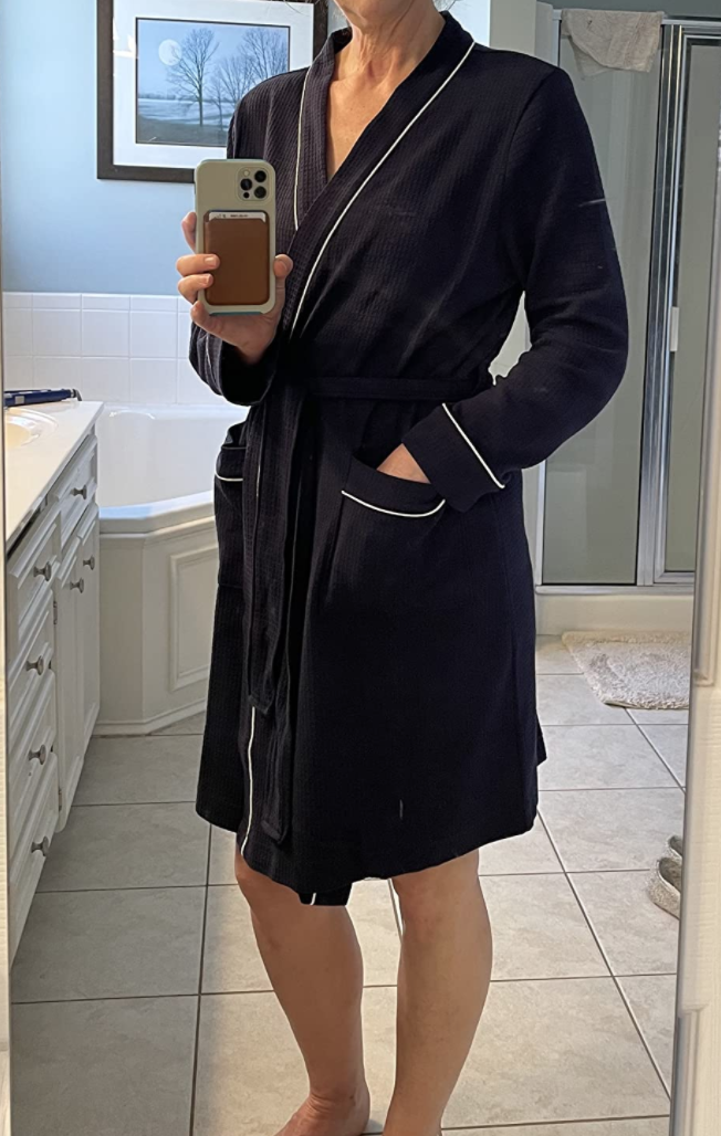 A reviewer wearing the robe in black