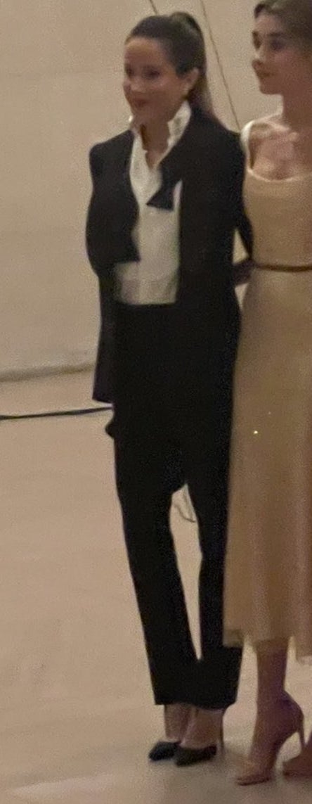 Close-up of Ashley Biden in a tux, untied bowtie, and high heels