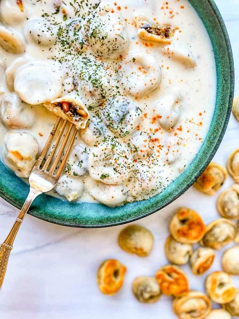 Middle Eastern dumplings topped with creamy sauce.