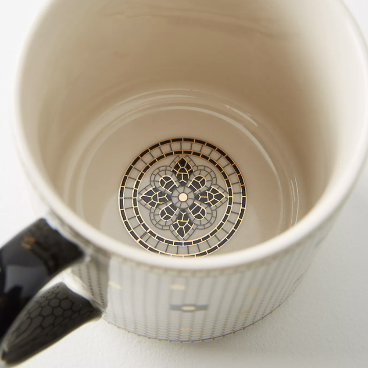 the inside of the mug with an art deco design in the bottom