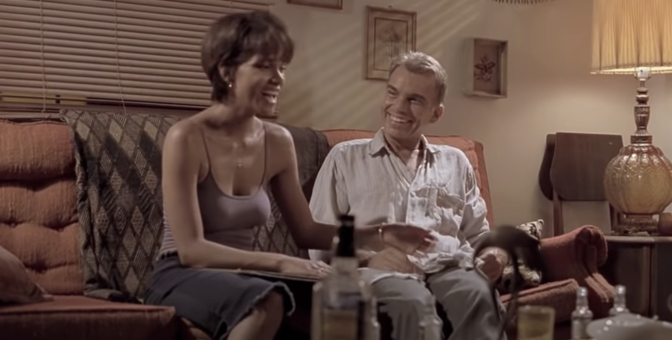 Halle Berry and Billy Bob Thornton laughing on the couch together in &quot;Monster&#x27;s Ball&quot;