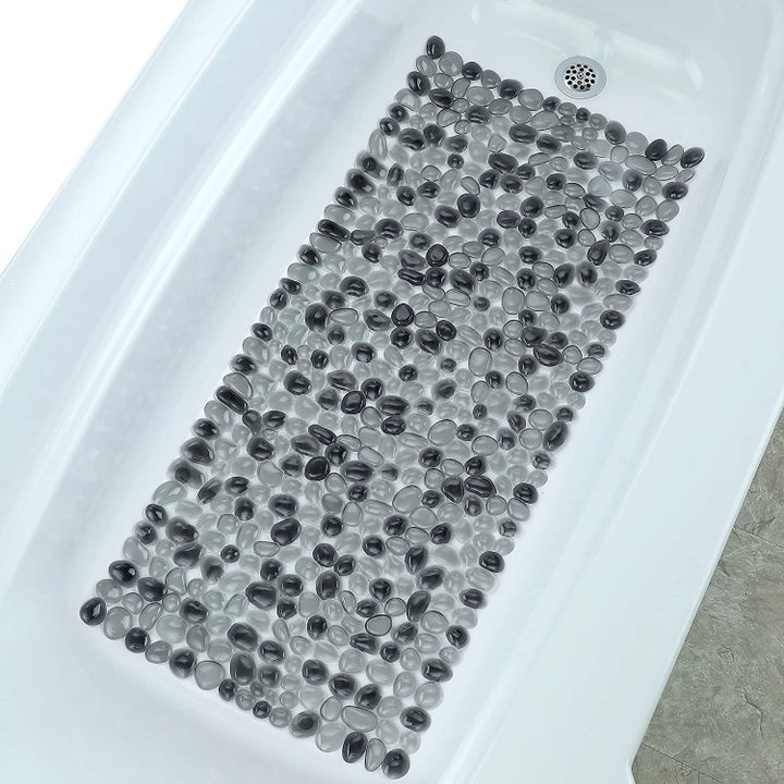 The shower mat in black in a shower