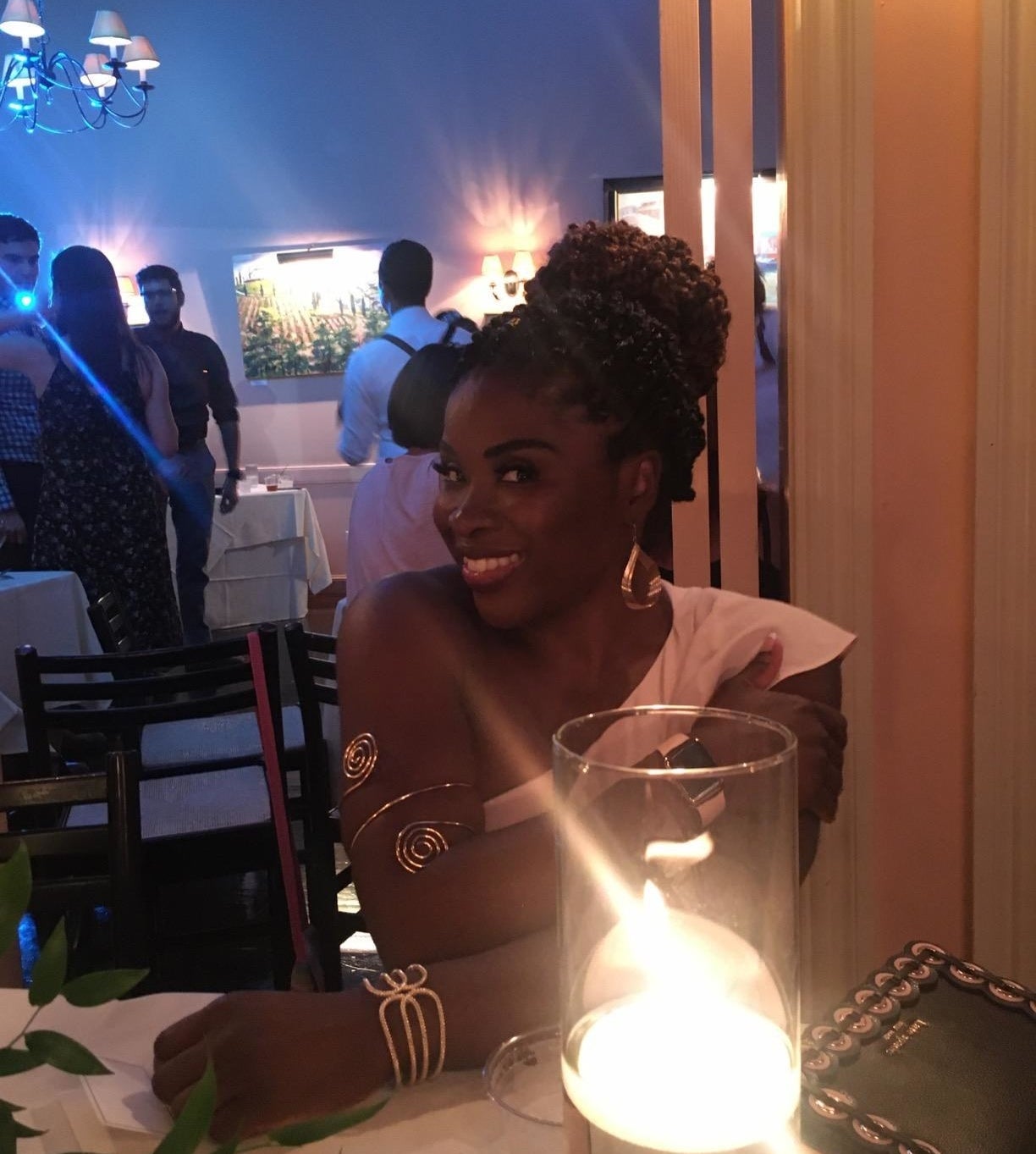 reviewer image of a customer wearing the rioso arm cuffs sitting at a candlelit table