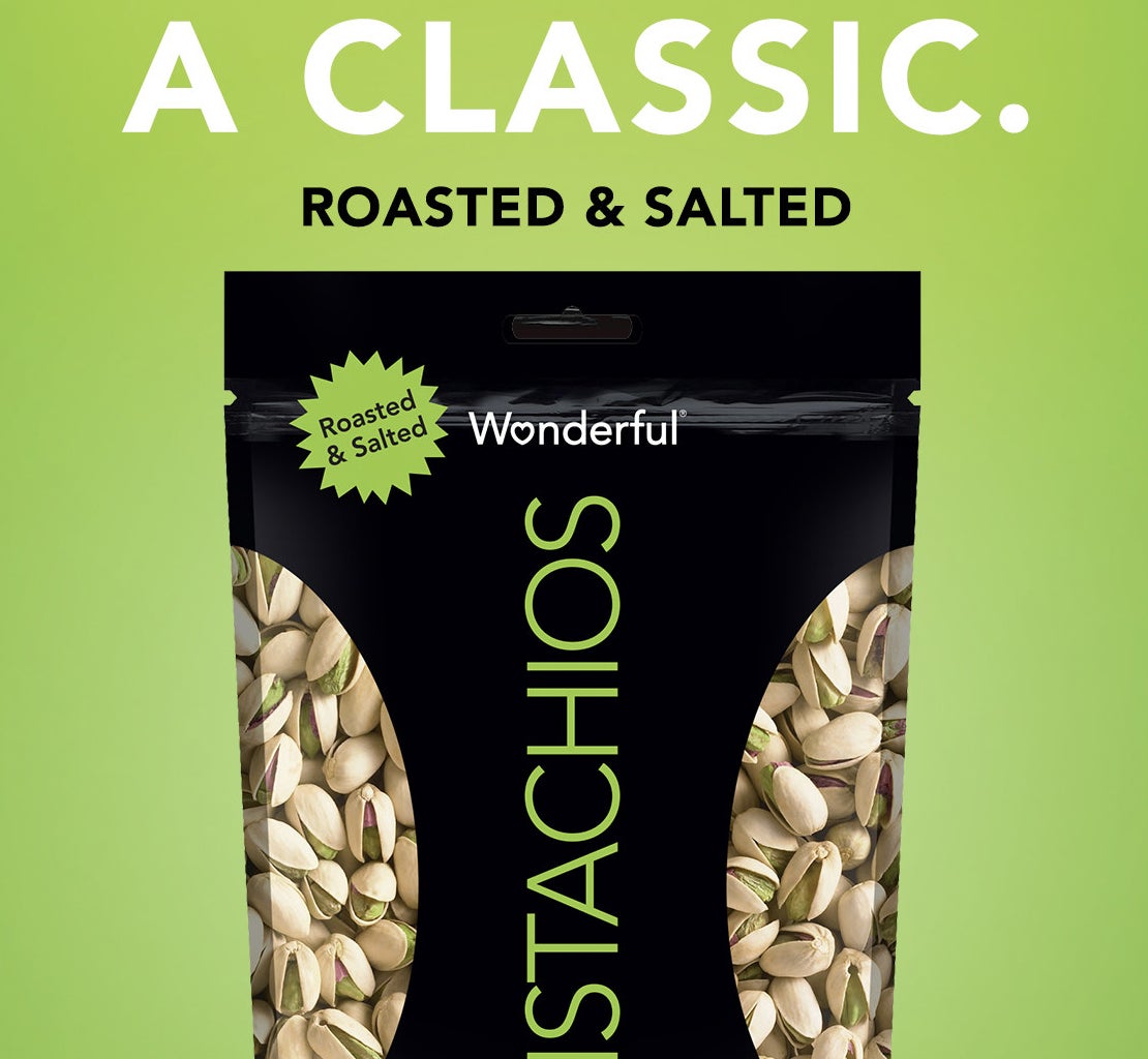 bag of wonderful pistachios on a green background