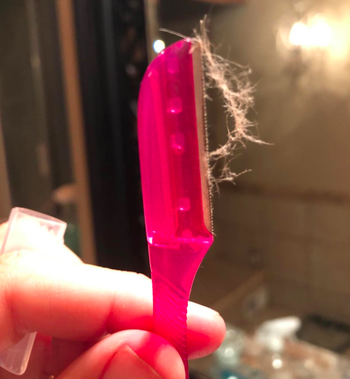 a reviewer showing a little bit of peach fuzz on the razor