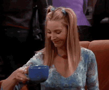 Phoebe from Friends smugly drinking coffee 