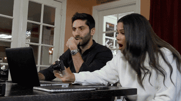 Nev and Kamie reacting to a computer screen with shock