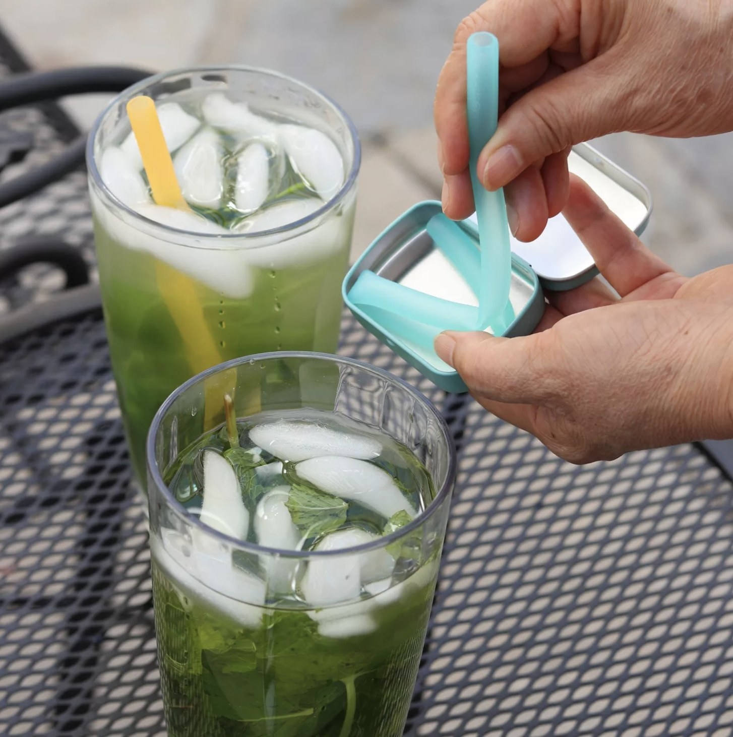 Person taking out reusable straw from tin