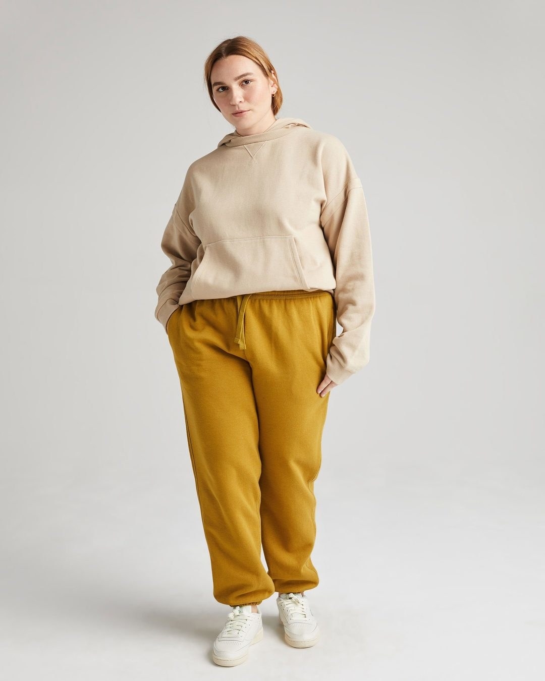 model wearing the golden yellow sweatpants