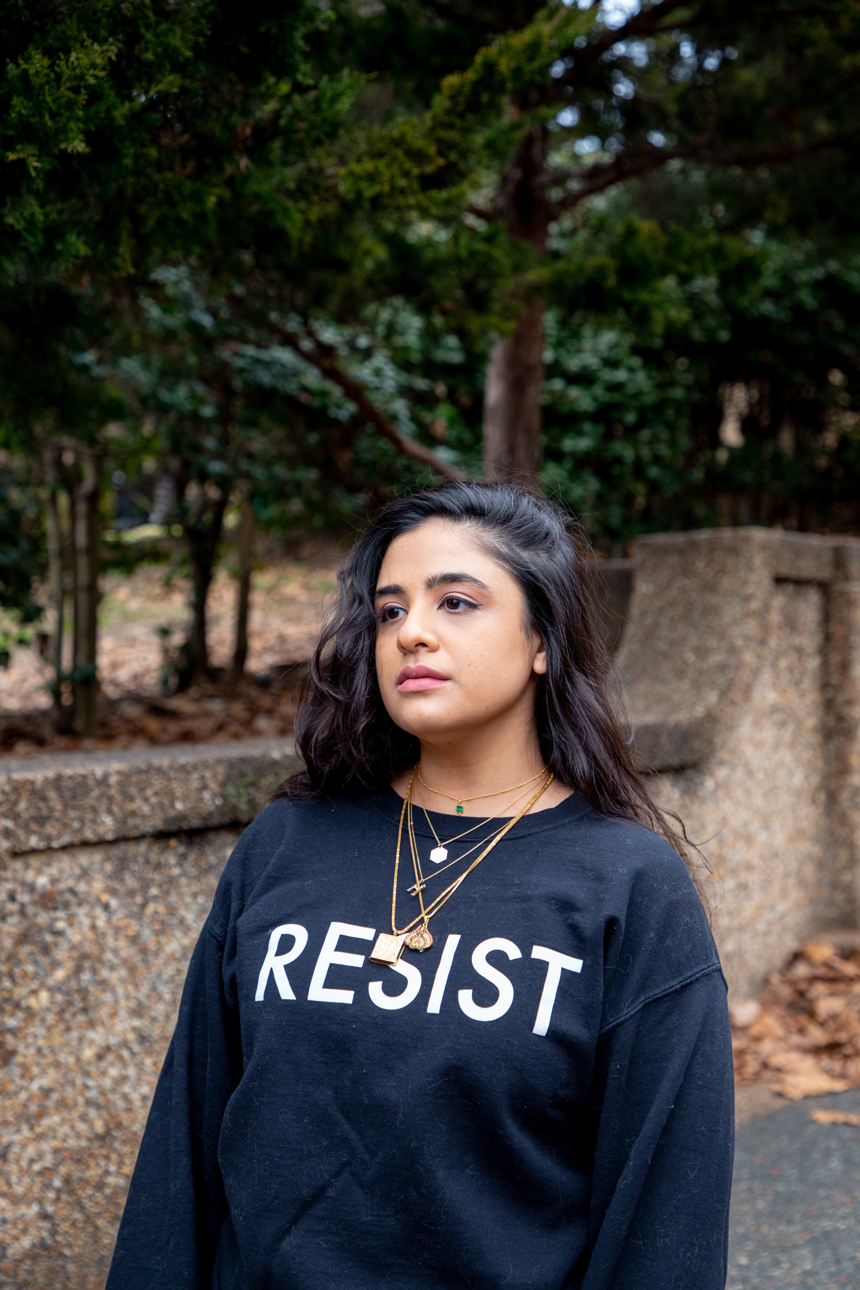 A young woman in a &quot;RESIST&quot; sweatshirt