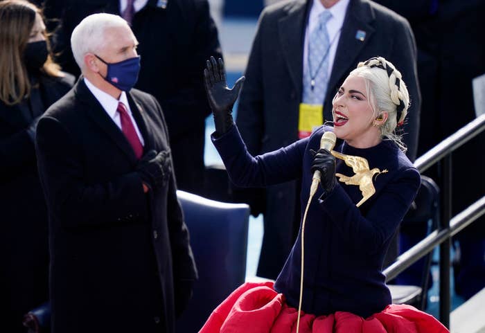 Lady Gaga belts out the National Anthem in a voluminous skirt and coat top featuring a dove carrying an olive branch