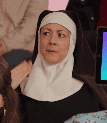 A gif of a nun fanning herself