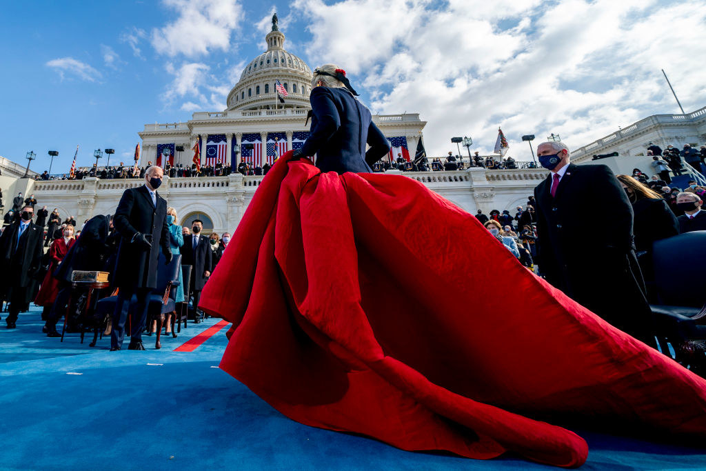 Lady Gaga walking offstage after her performance as Mike Pence looks on