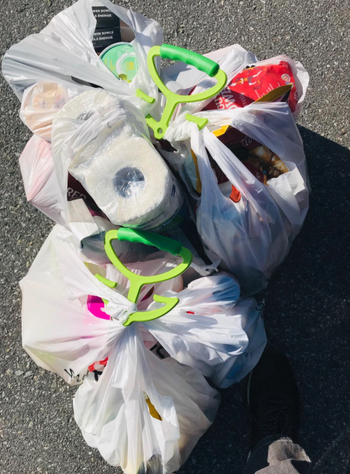 reviewer image of handles holding multiple bags of groceries