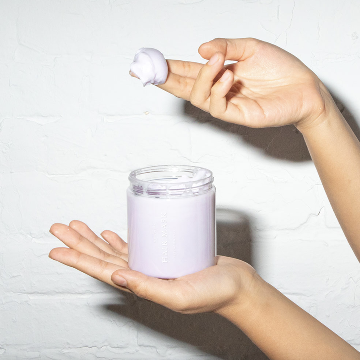Model scooping hair mask from jar