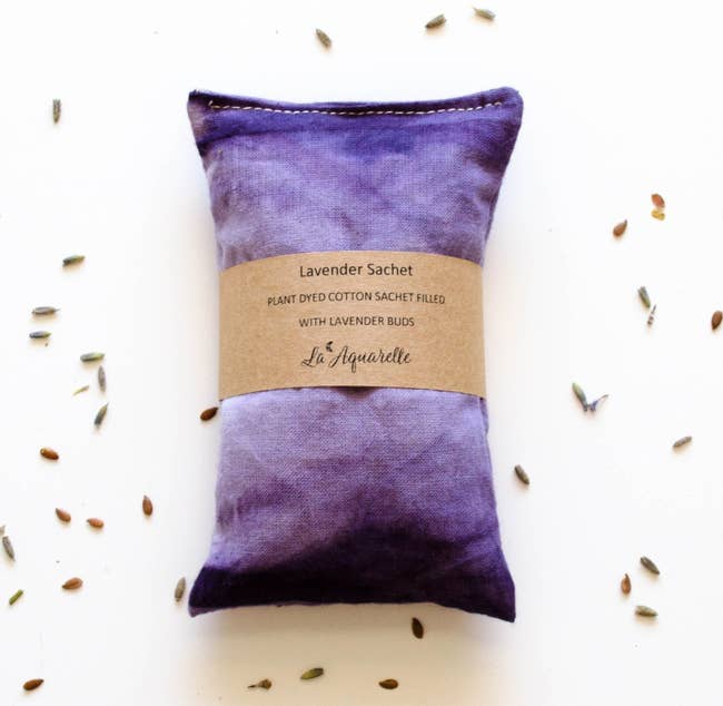 A purple dyed stitched pillow with lavender in it 