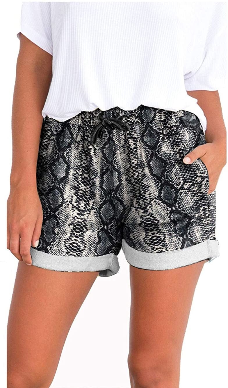 Model wears snakeskin-print drawstring shorts with a ribbed tee
