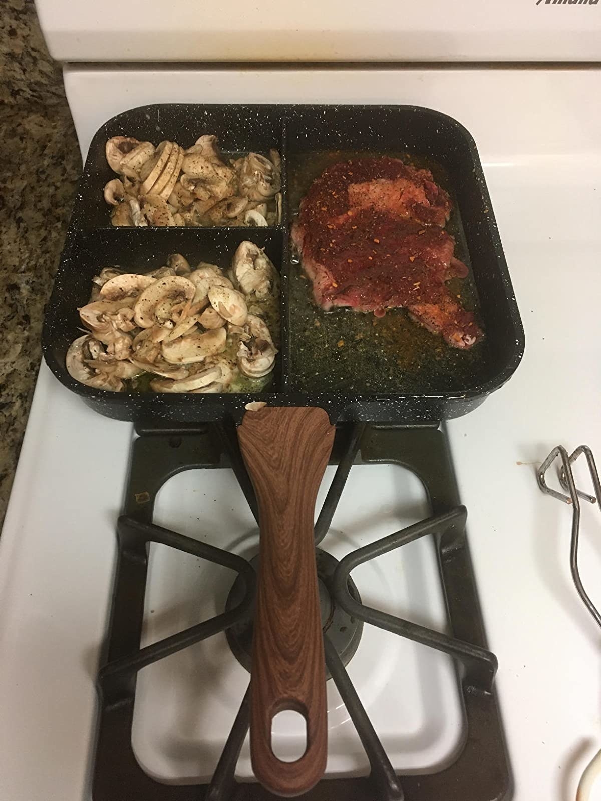 Reviewer sectioned pan in use on stove cooking meat and mushrooms