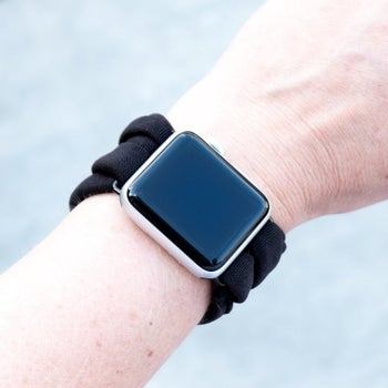 A model wearing an Apple Watch with a soft multiloop black band 
