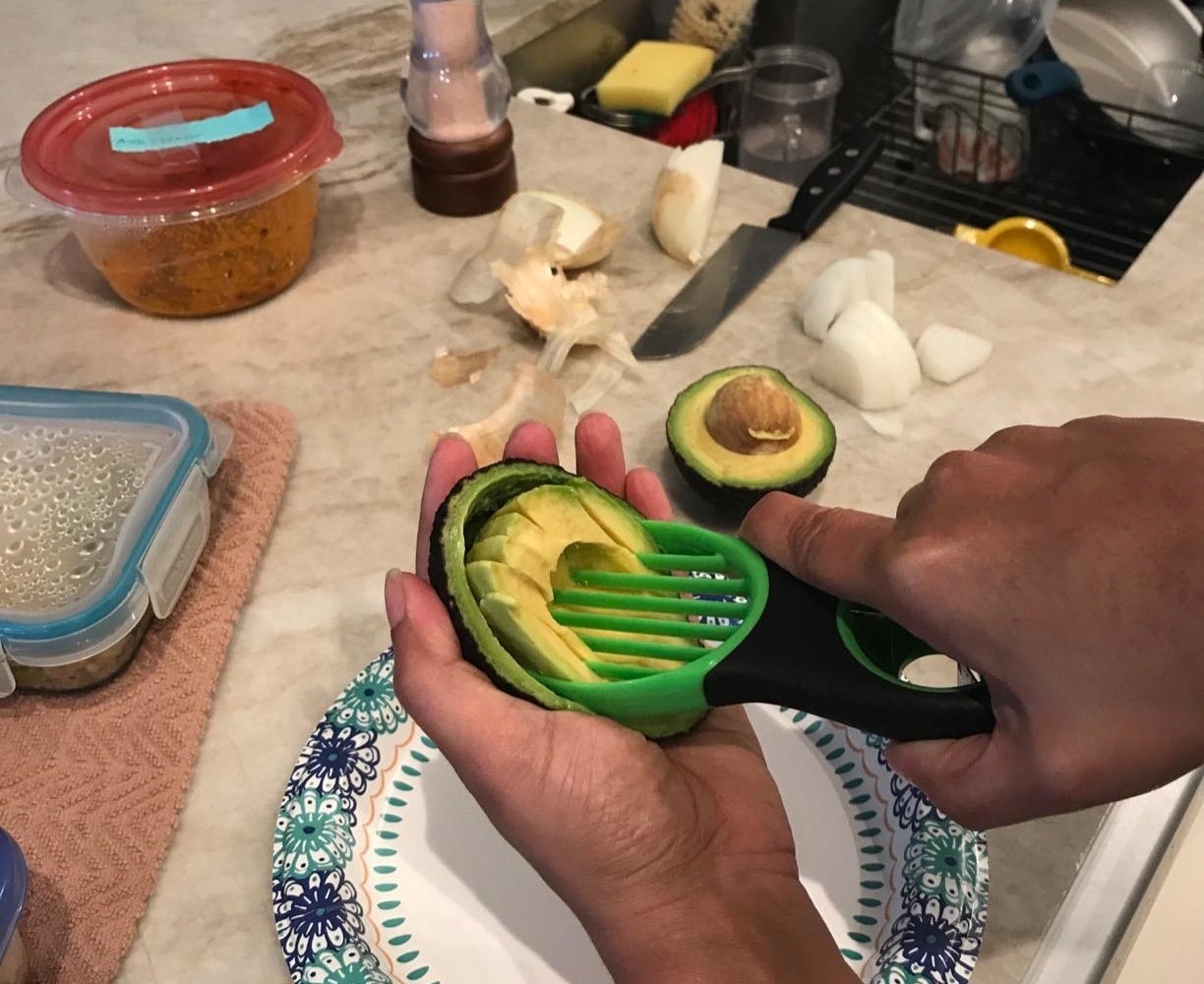 Reviewer slicing avocado with product