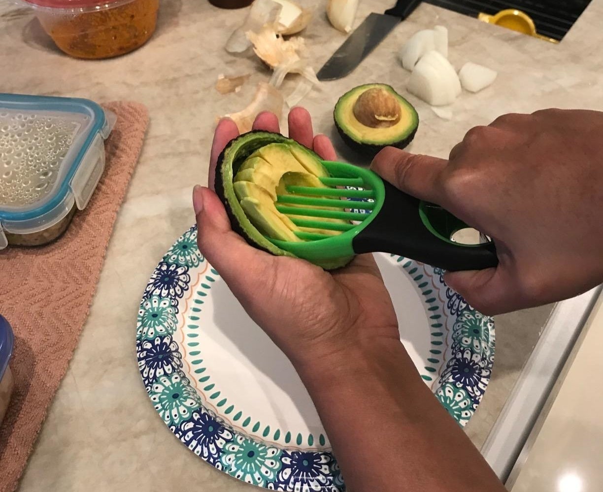 Reviewer slicing avocado with product