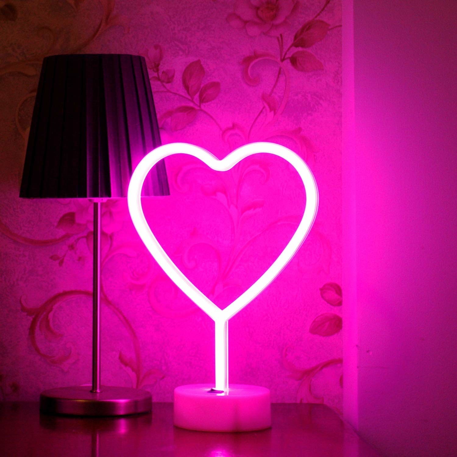 A neon pink heart lamp.