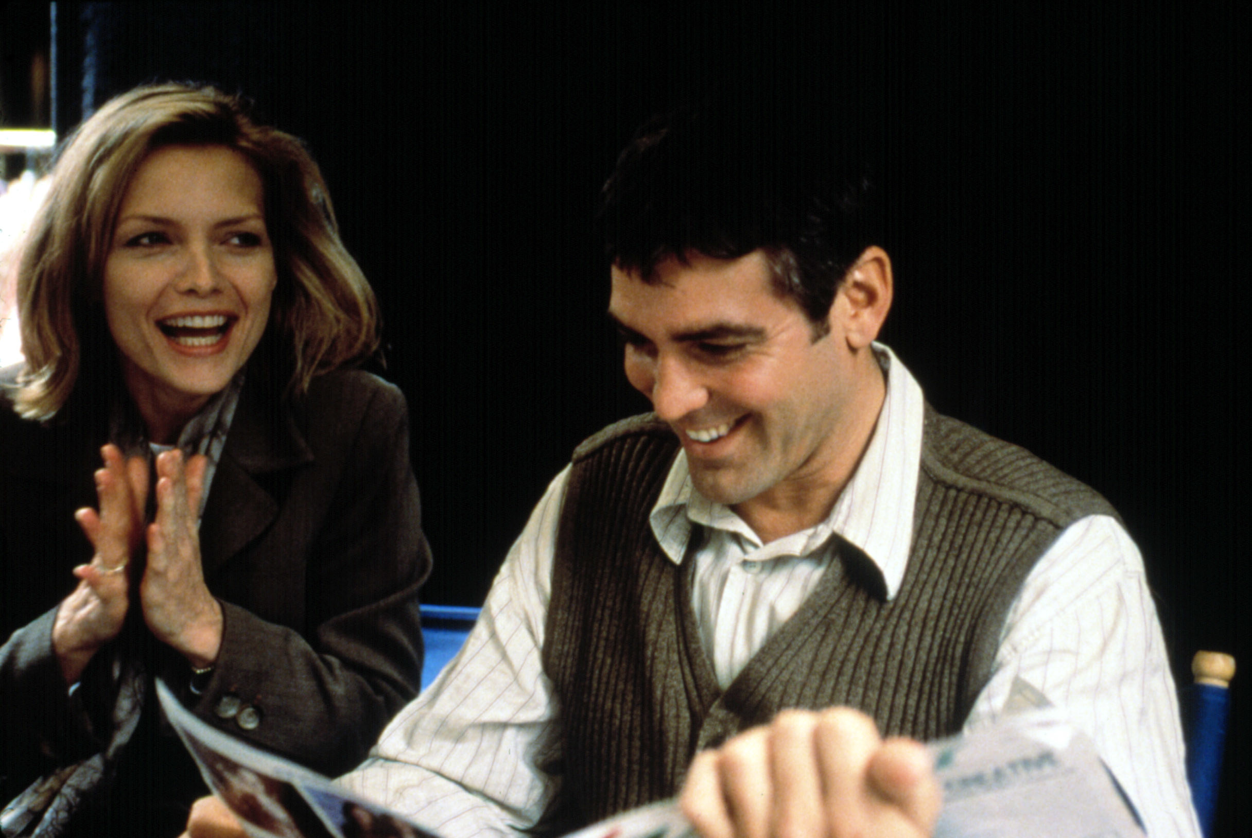 Michelle Pfeiffer and George Clooney laughing together in One Fine Day