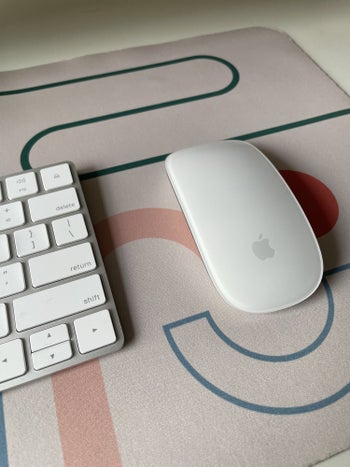 BuzzFeed editors Magic Mouse and keyboard on the geometric desk mat