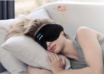Model wearing a black eye mask and sleeping 