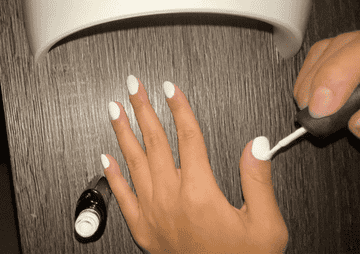 BuzzFeed employee painting nail