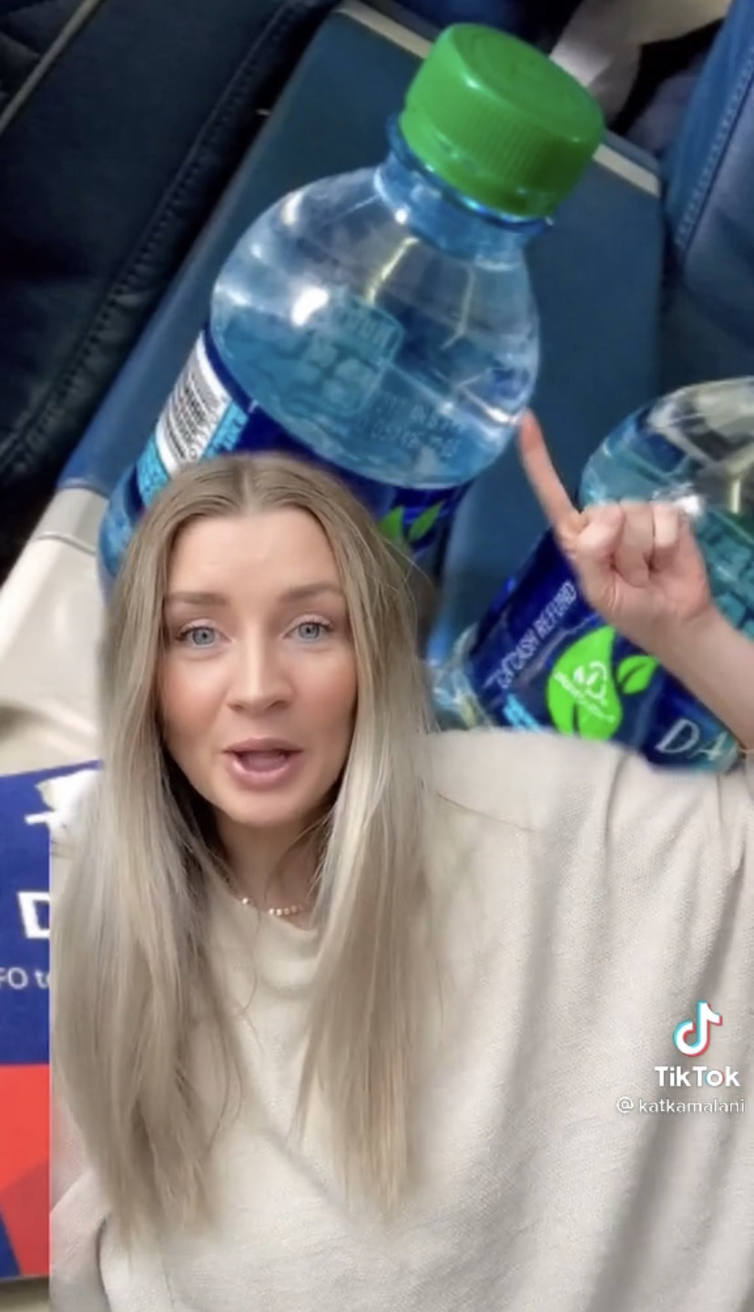 Kat pointing to a bottle of water